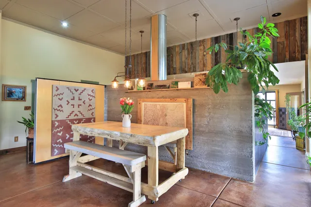 a living room with patio furniture and a potted plant