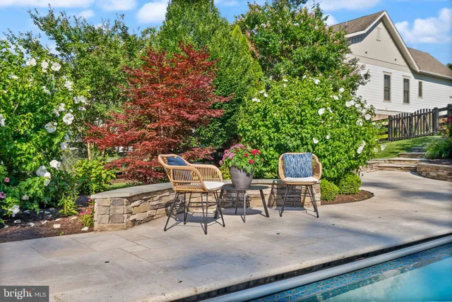 a living room with furniture a table and painting on the wall