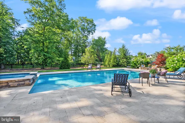 a view of a swimming pool with a chair and tables