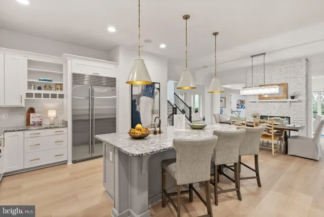 a living room with furniture a couch and a view of kitchen