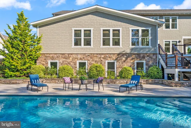 a view of a swimming pool with an outdoor seating yard and mountain view in back