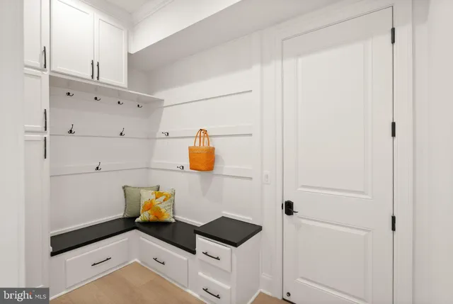 a front view of a house with a yard and lake view