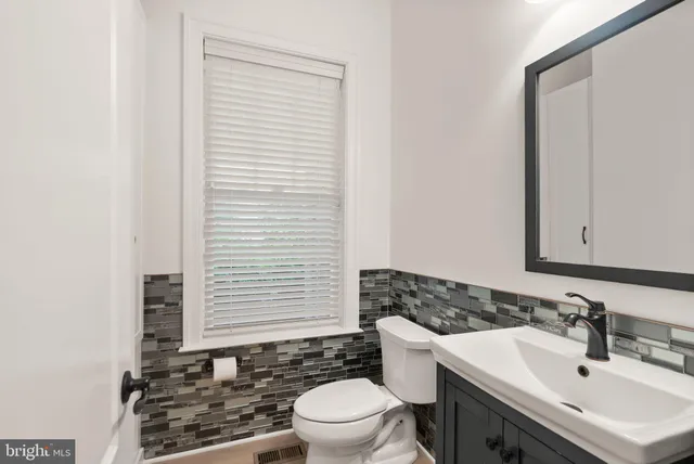a front view of a house with a yard table and chairs