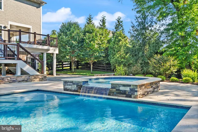 a view of a living room and dining room with furniture wooden floor and windows