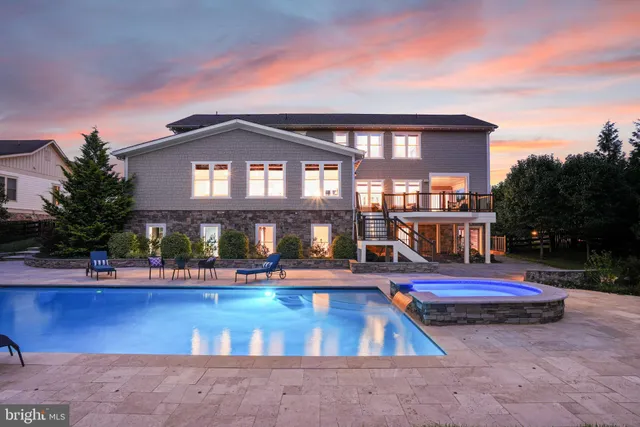 a living room with furniture fireplace and a large window