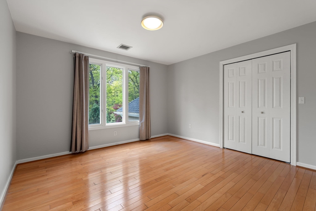 11 Black Elk Road Sharon, MA 02067 - Photo 19 of 28 a view of an empty room with wooden floor and a window
