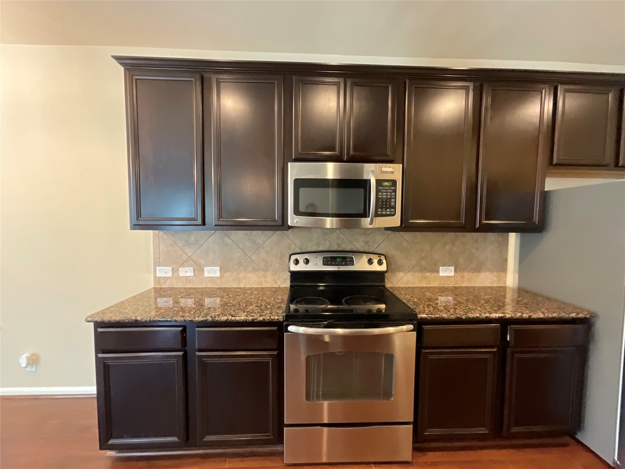 1911 Conn Creek Road Cedar Park, TX 78613 - Photo 17 of 39 a kitchen with granite countertop stainless steel appliances and cabinets