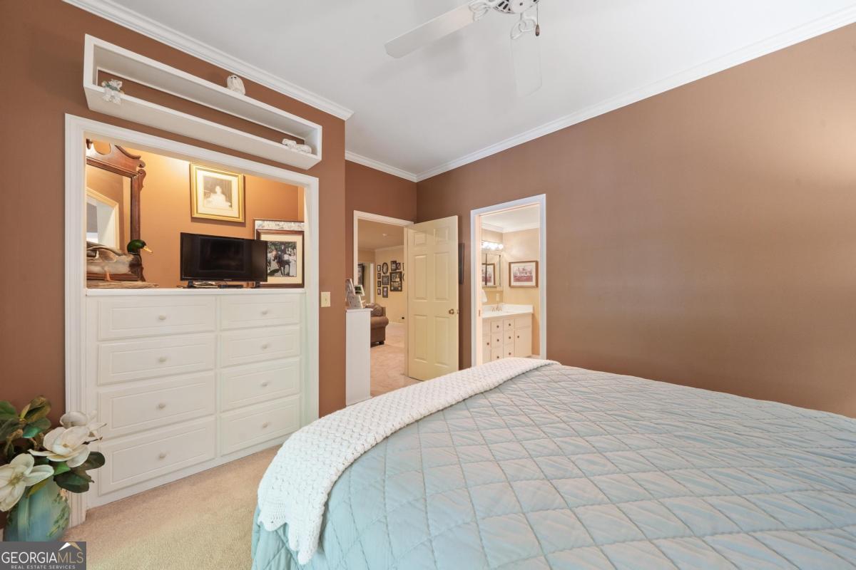 1031 Old Still Road Greensboro, GA 30642 - Photo 58 of 73 a bedroom with a bed and a flat screen tv