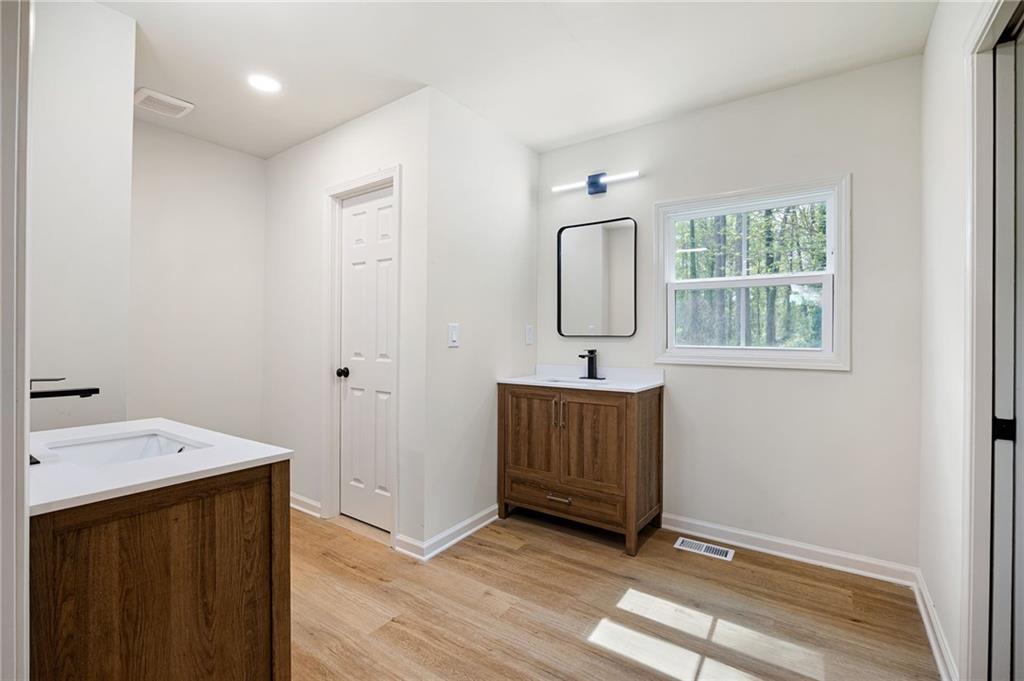 4289 Kimball Road Southwest Atlanta, GA 30331 - Photo 10 of 20 a view of a bathroom with 2 sink window and wooden floor