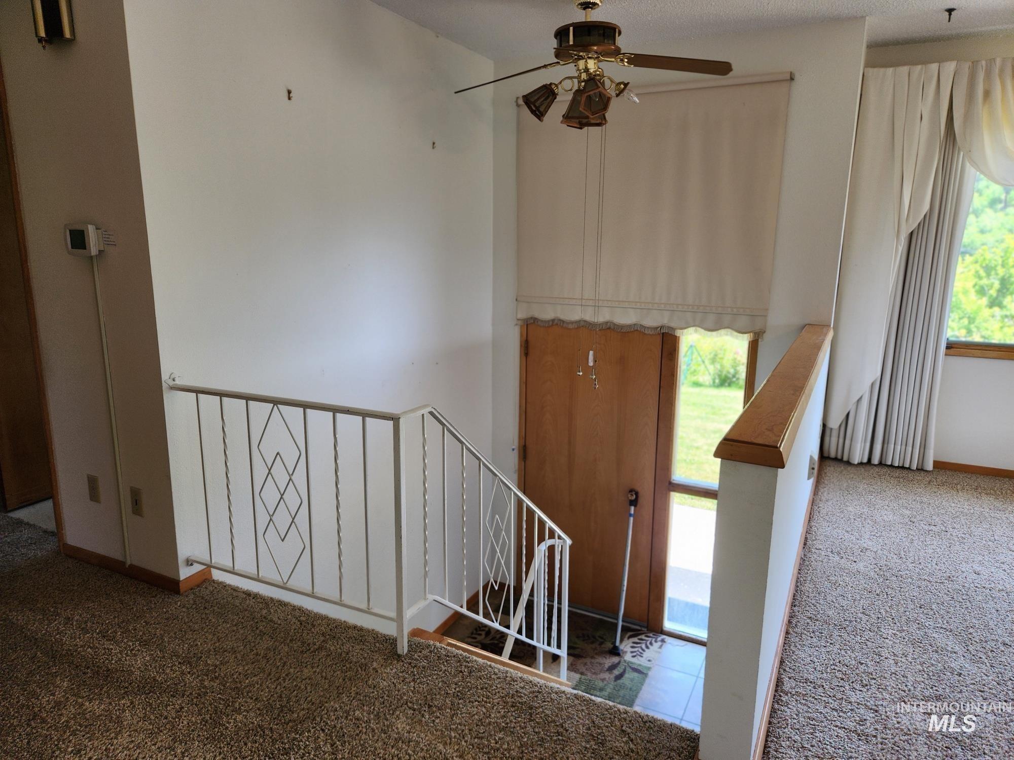 367 Woodland Road Kamiah, ID 83536 - Photo 18 of 49 Stairs with carpet floors and a ceiling fan