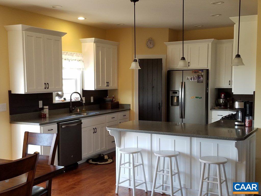 913 Plank Road Farmville, VA 23901 - Photo 5 of 16 a kitchen with stainless steel appliances granite countertop a refrigerator a stove a sink a dining table and chairs with wooden floor