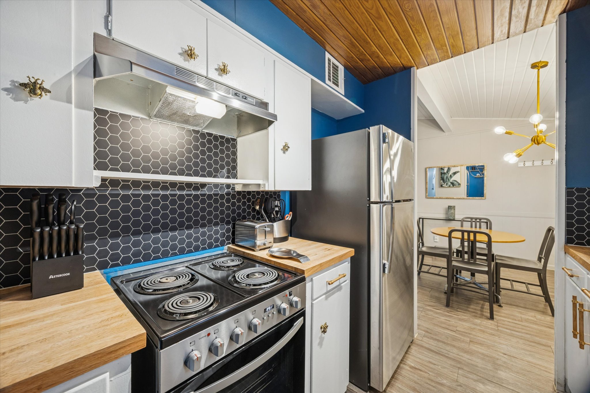 211 Lessin Lane, Unit C Austin, TX 78704 - Photo 11 of 14 a kitchen with stainless steel appliances granite countertop a refrigerator and a stove top oven