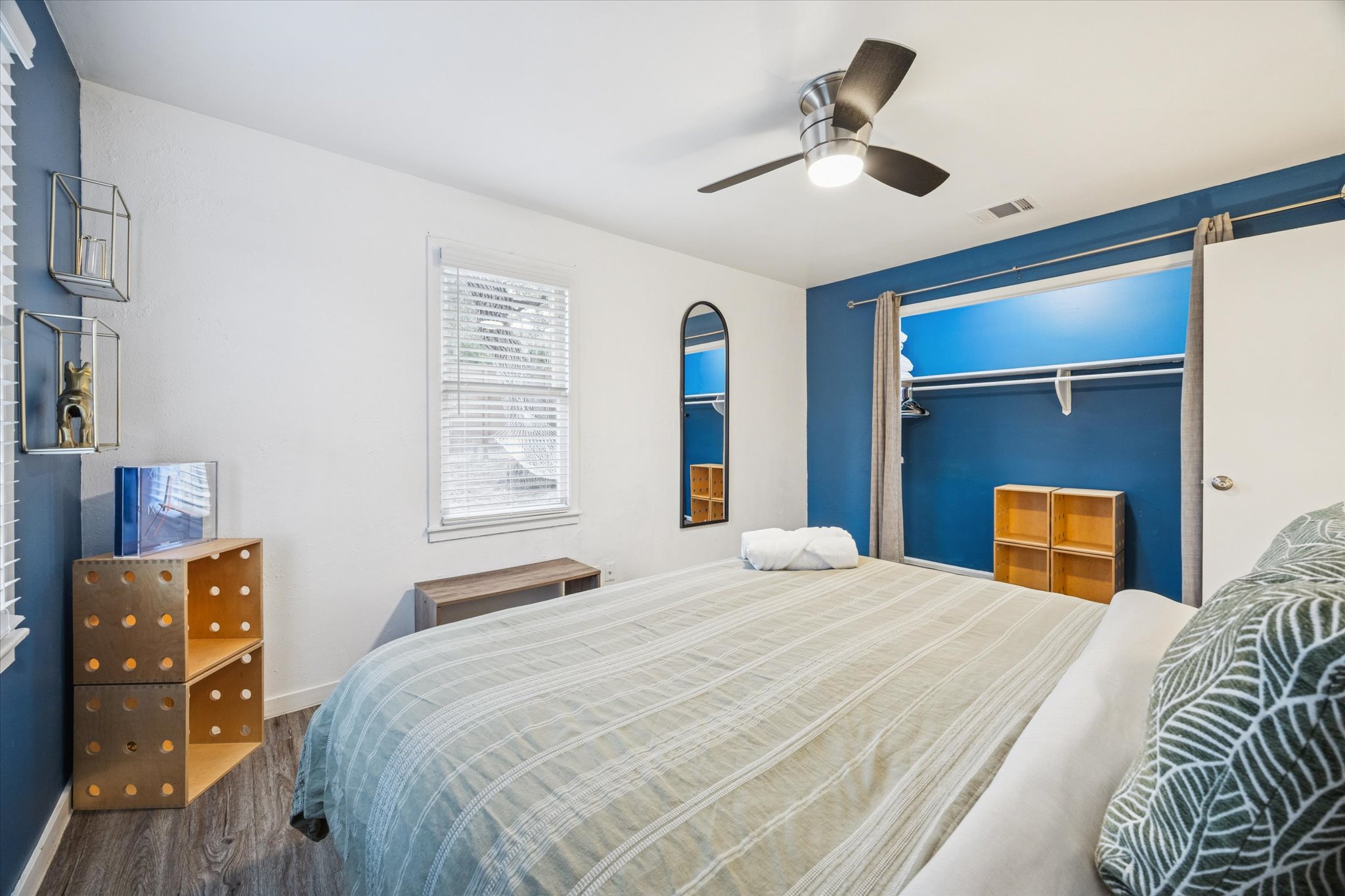 211 Lessin Lane, Unit C Austin, TX 78704 - Photo 13 of 14 a bedroom with a bed and a chandelier