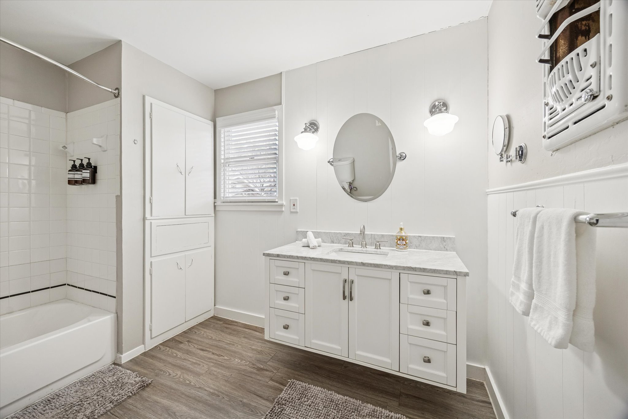 211 Lessin Lane, Unit C Austin, TX 78704 - Photo 14 of 14 a bathroom with a granite countertop sink a mirror a vanity and a bathtub