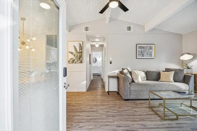 a living room with furniture and a wooden floor