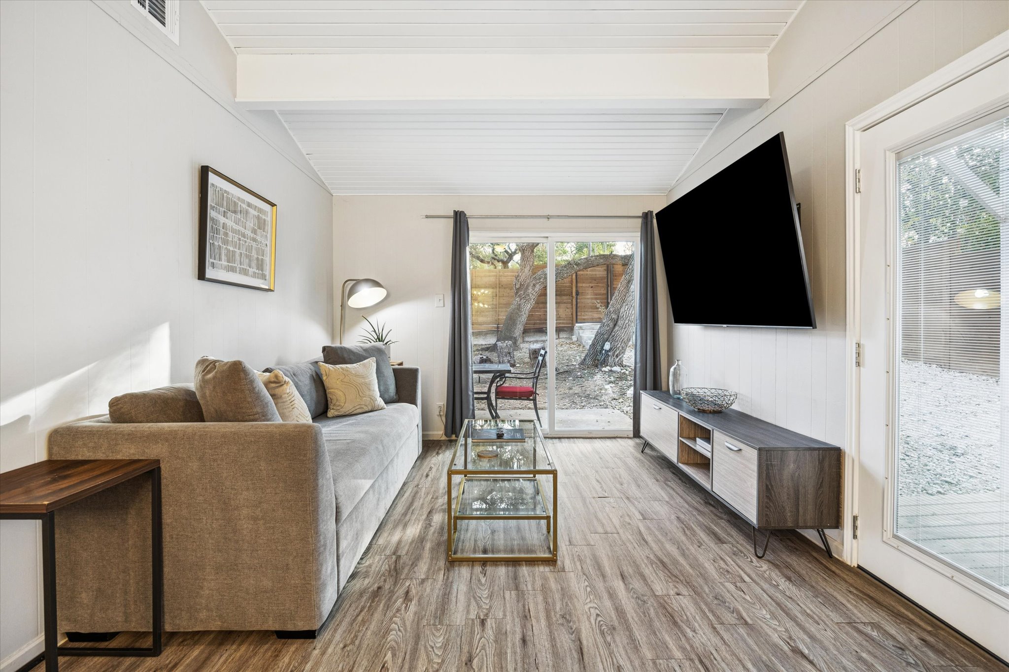 211 Lessin Lane, Unit C Austin, TX 78704 - Photo 6 of 14 a living room with furniture and a flat screen tv