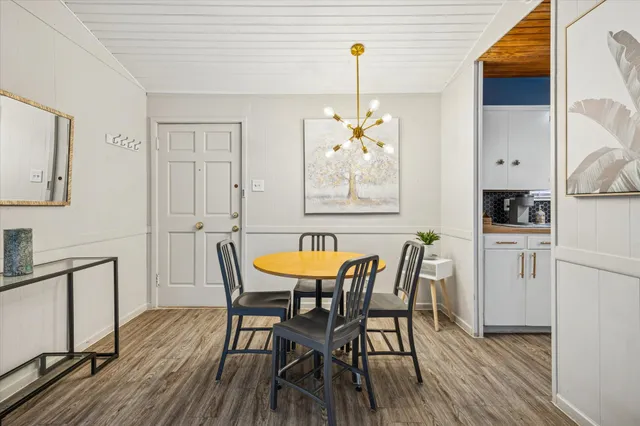 a view of a dining room with furniture and wooden floor