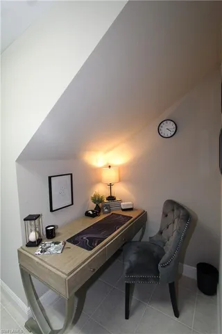 a living room with a table chairs and a window