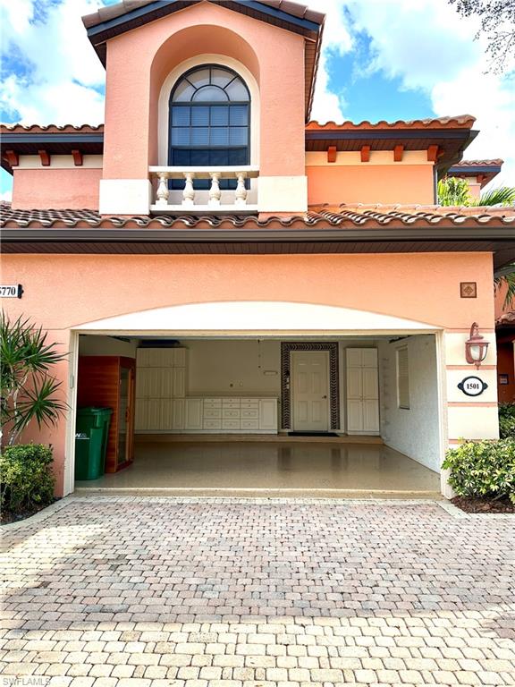 5770 Grande Reserve Way, Unit 1501 Naples, FL 34110 - Photo 16 of 18 a front view of a house with lake view