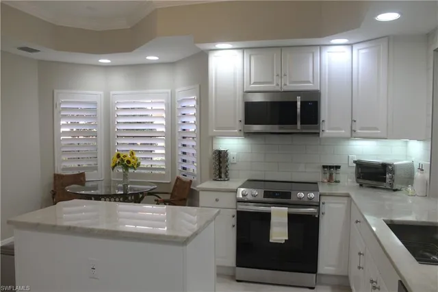 a kitchen with stainless steel appliances wooden cabinets and a stove top oven