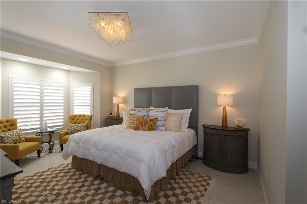 5770 Grande Reserve Way, Unit 1501 Naples, FL 34110 - Photo 7 of 18 a bedroom with a bed and a lamp