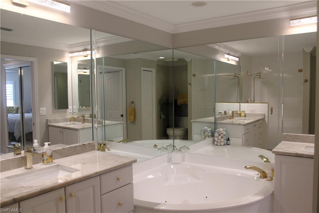 5770 Grande Reserve Way, Unit 1501 Naples, FL 34110 - Photo 8 of 18 a bathroom with a double vanity sink mirror and double