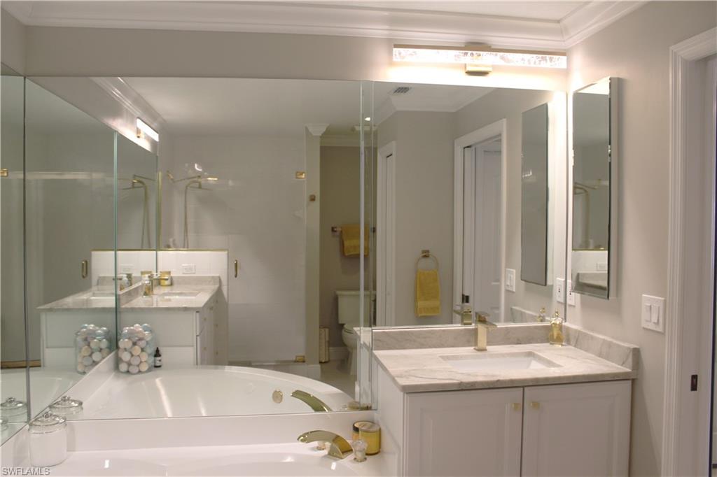 5770 Grande Reserve Way, Unit 1501 Naples, FL 34110 - Photo 9 of 18 a bathroom with a sink and a mirror