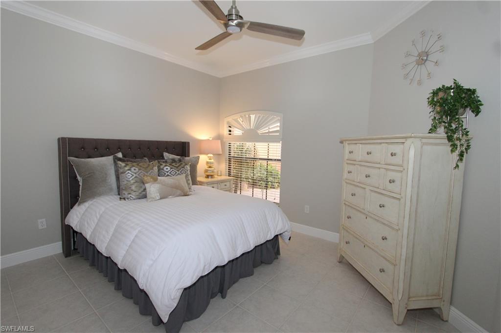 5770 Grande Reserve Way, Unit 1501 Naples, FL 34110 - Photo 10 of 18 a bedroom with a bed and a window