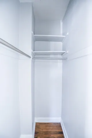 a view of walk in closet with empty racks