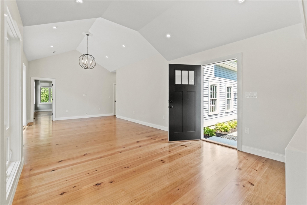 473 Main Street Amesbury, MA 01913 - Photo 11 of 42 a view of an empty room with wooden floor and a window
