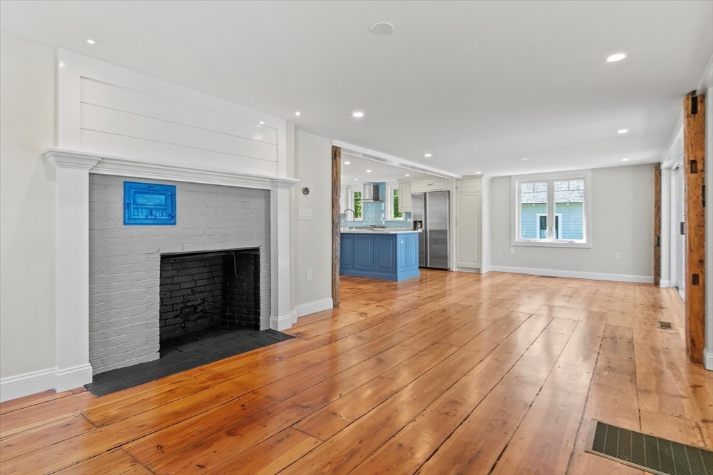 473 Main Street Amesbury, MA 01913 - Photo 18 of 42 a view of an empty room with a fireplace and a window
