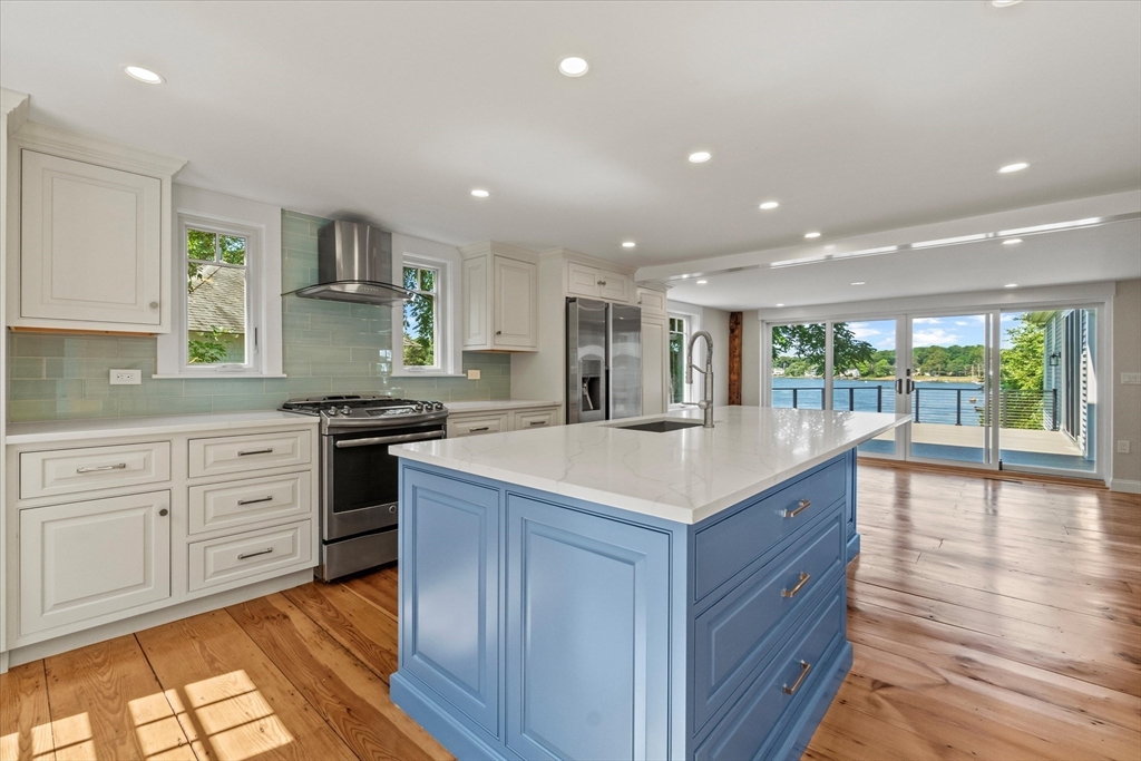 473 Main Street Amesbury, MA 01913 - Photo 2 of 42 a kitchen with stainless steel appliances kitchen island granite countertop a stove and a sink