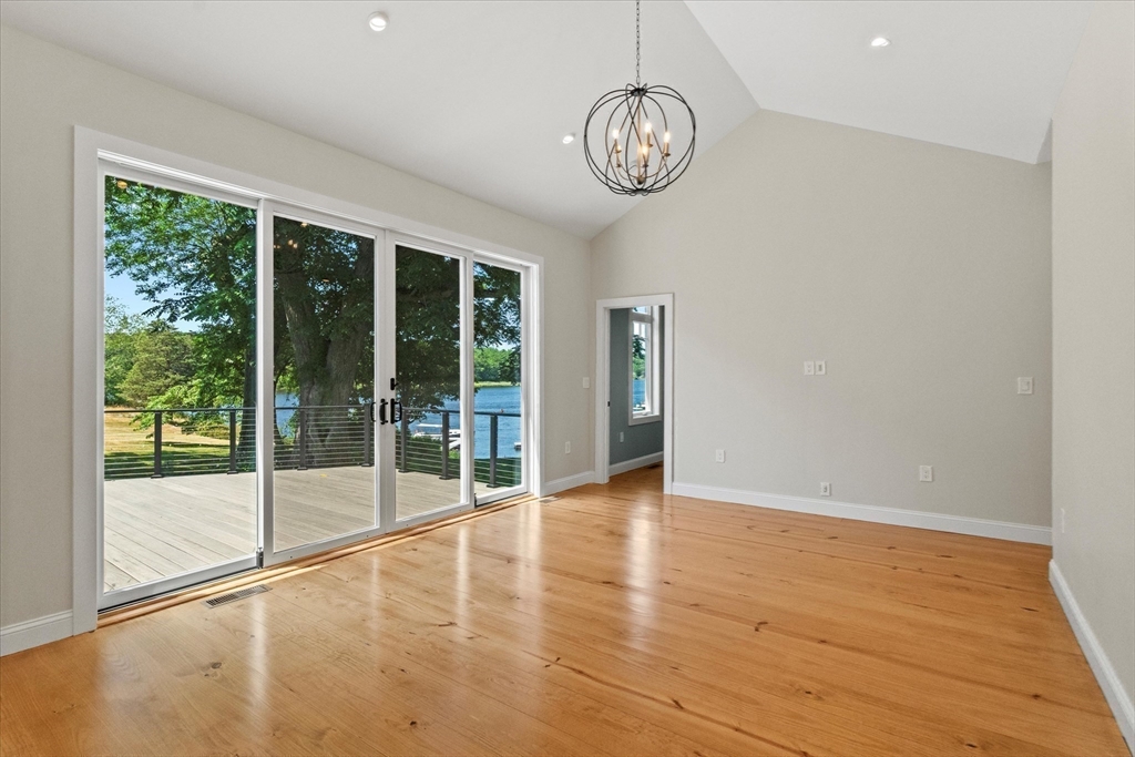473 Main Street Amesbury, MA 01913 - Photo 22 of 42 a view of an empty room with wooden floor and a window