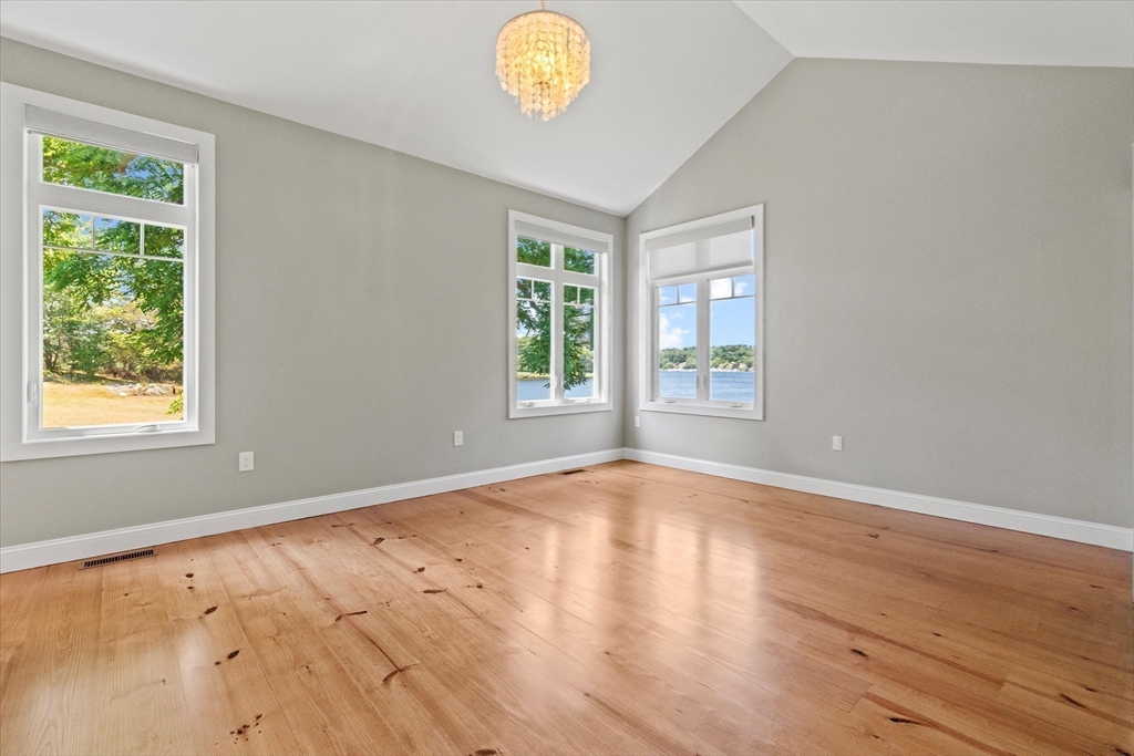 473 Main Street Amesbury, MA 01913 - Photo 24 of 42 a view of an empty room with window and wooden floor