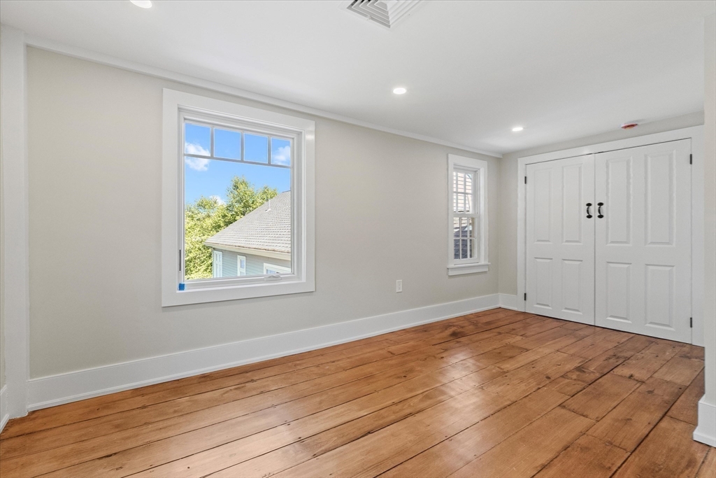 473 Main Street Amesbury, MA 01913 - Photo 30 of 42 a view of an empty room with wooden floor and a window