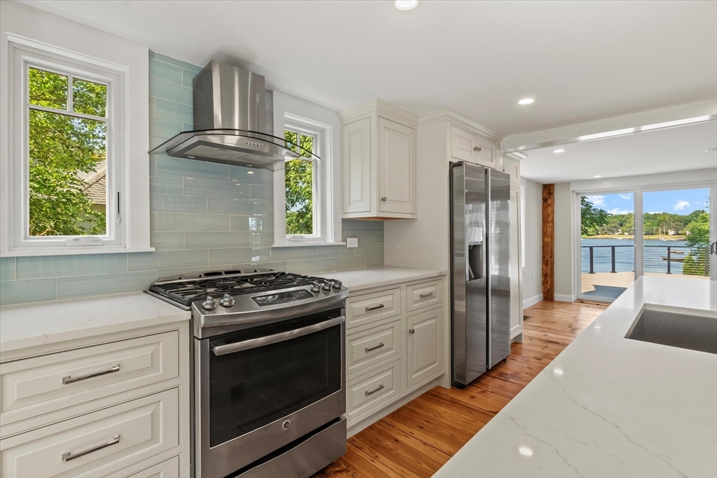 473 Main Street Amesbury, MA 01913 - Photo 3 of 42 a kitchen with stainless steel appliances a stove a sink and a refrigerator