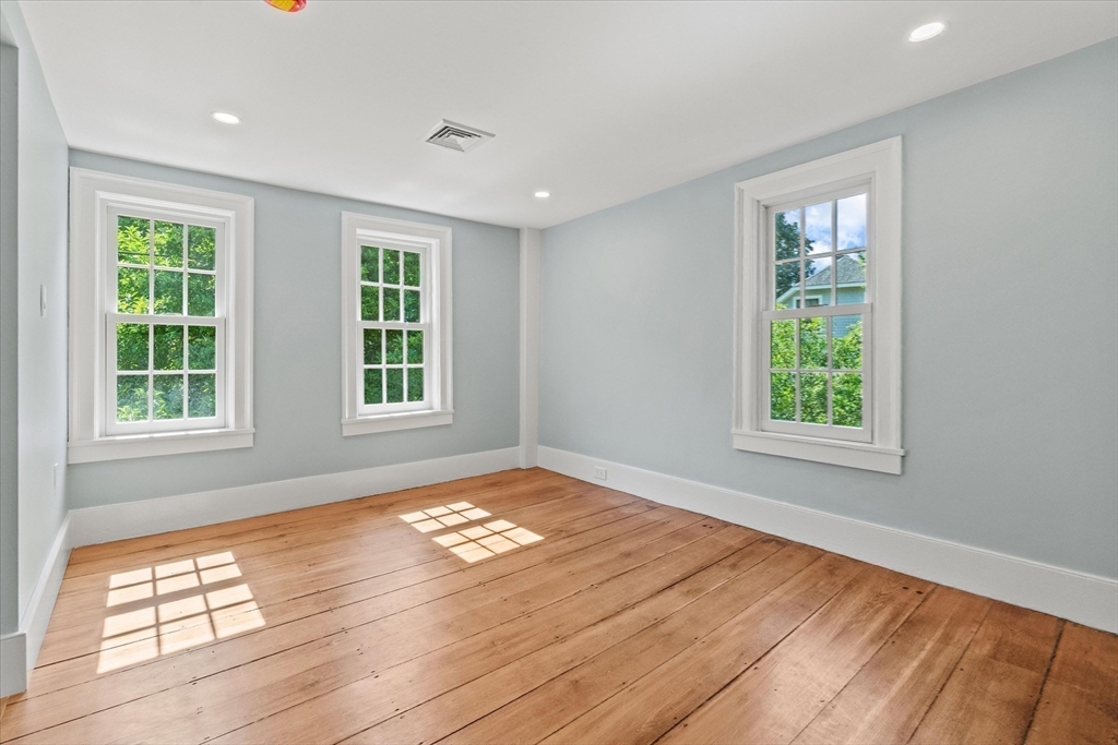 473 Main Street Amesbury, MA 01913 - Photo 32 of 42 a view of an empty room with wooden floor and a window