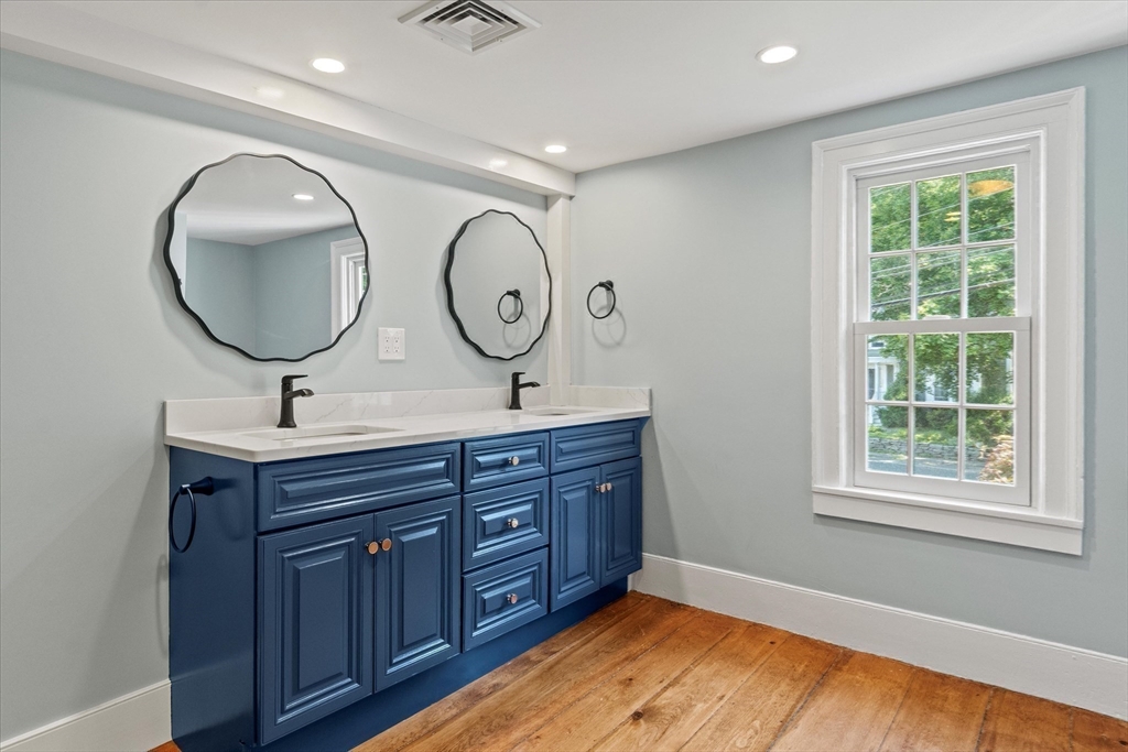 473 Main Street Amesbury, MA 01913 - Photo 33 of 42 a bathroom with a double vanity sink and a mirror