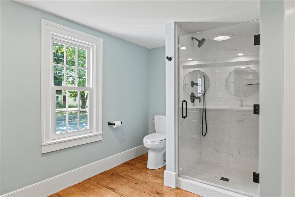 473 Main Street Amesbury, MA 01913 - Photo 34 of 42 a bathroom with a glass shower door