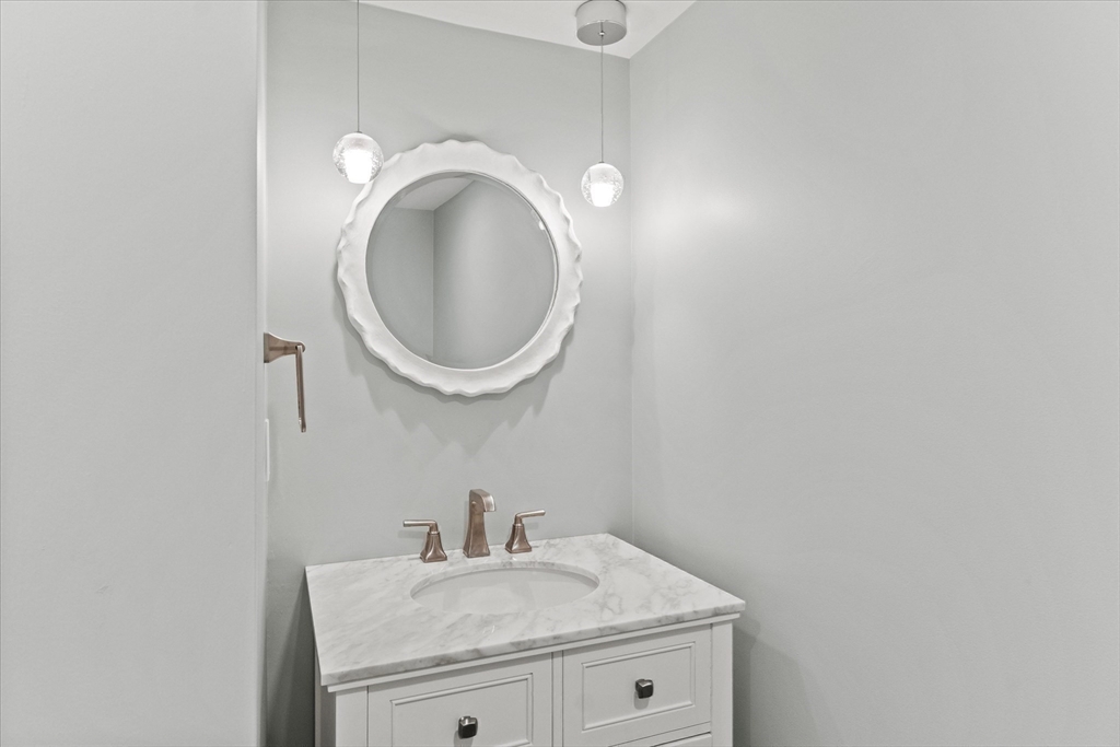 473 Main Street Amesbury, MA 01913 - Photo 36 of 42 a bathroom with a sink and a mirror