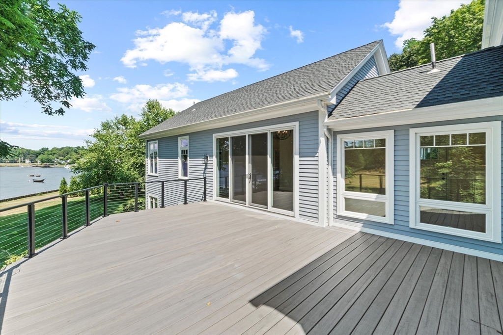 473 Main Street Amesbury, MA 01913 - Photo 38 of 42 a view of backyard with large trees and a wooden fence