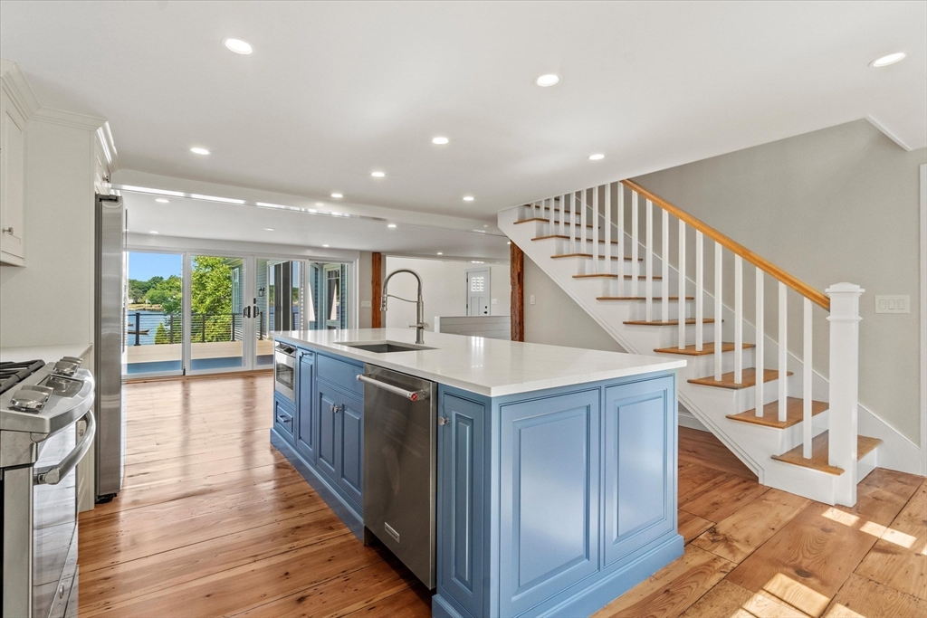 473 Main Street Amesbury, MA 01913 - Photo 4 of 42 a kitchen with kitchen island granite countertop a stove and a wooden floor
