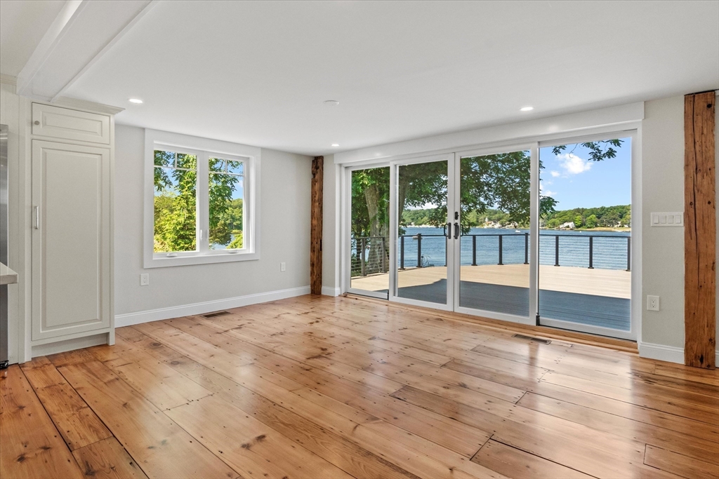 473 Main Street Amesbury, MA 01913 - Photo 7 of 42 a view of an empty room with wooden floor and a window