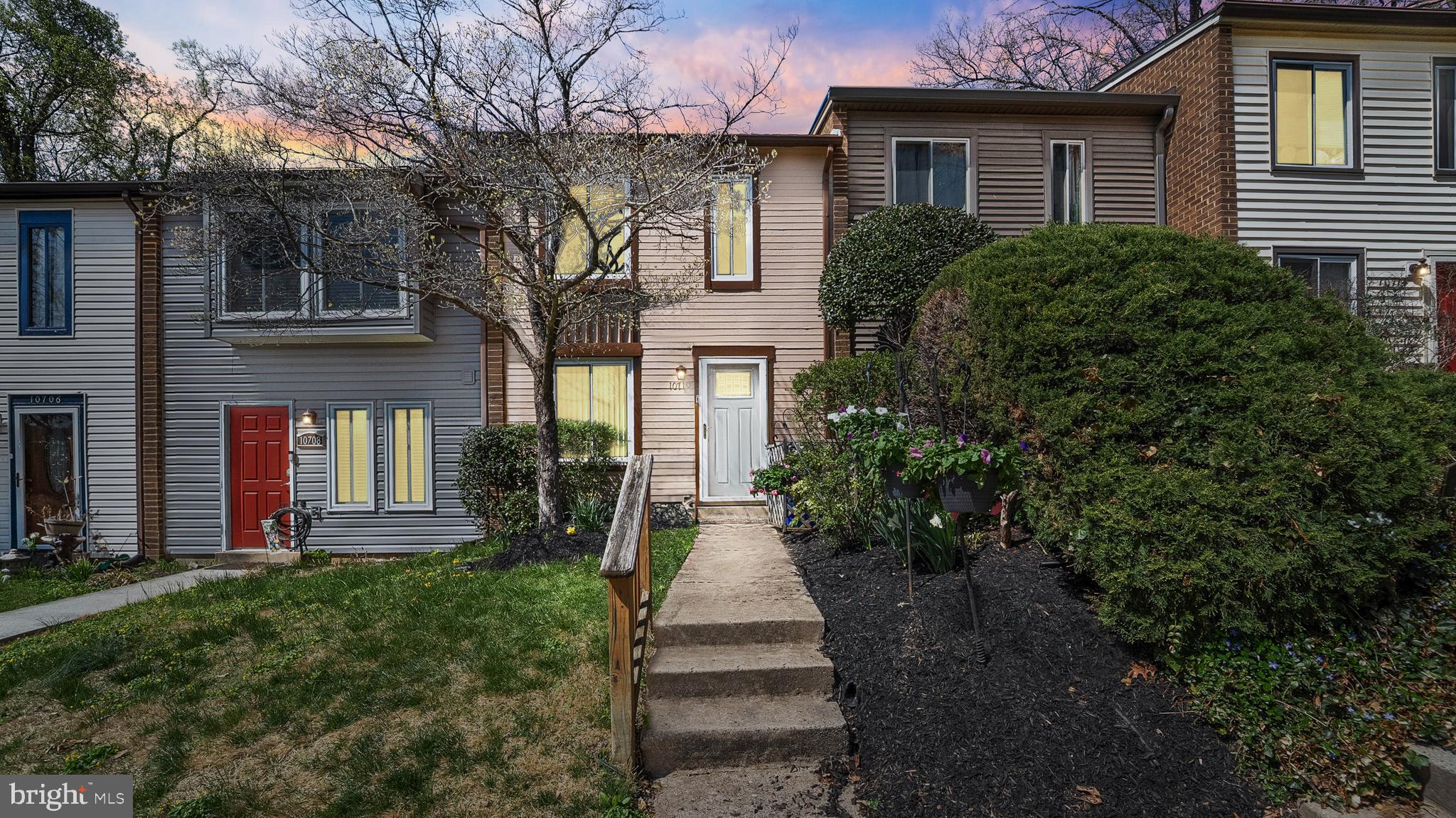 a front view of a house with a yard and outdoor seating
