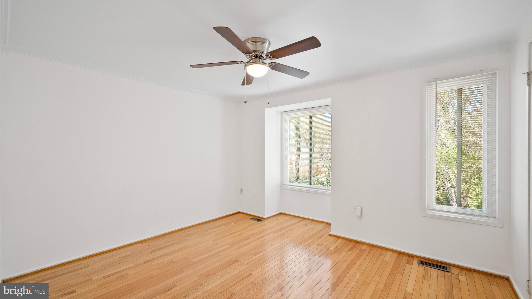 10710 Lester Street Silver Spring, MD 20902 - Photo 12 of 24 a view of empty room with wooden floor and ceiling fan