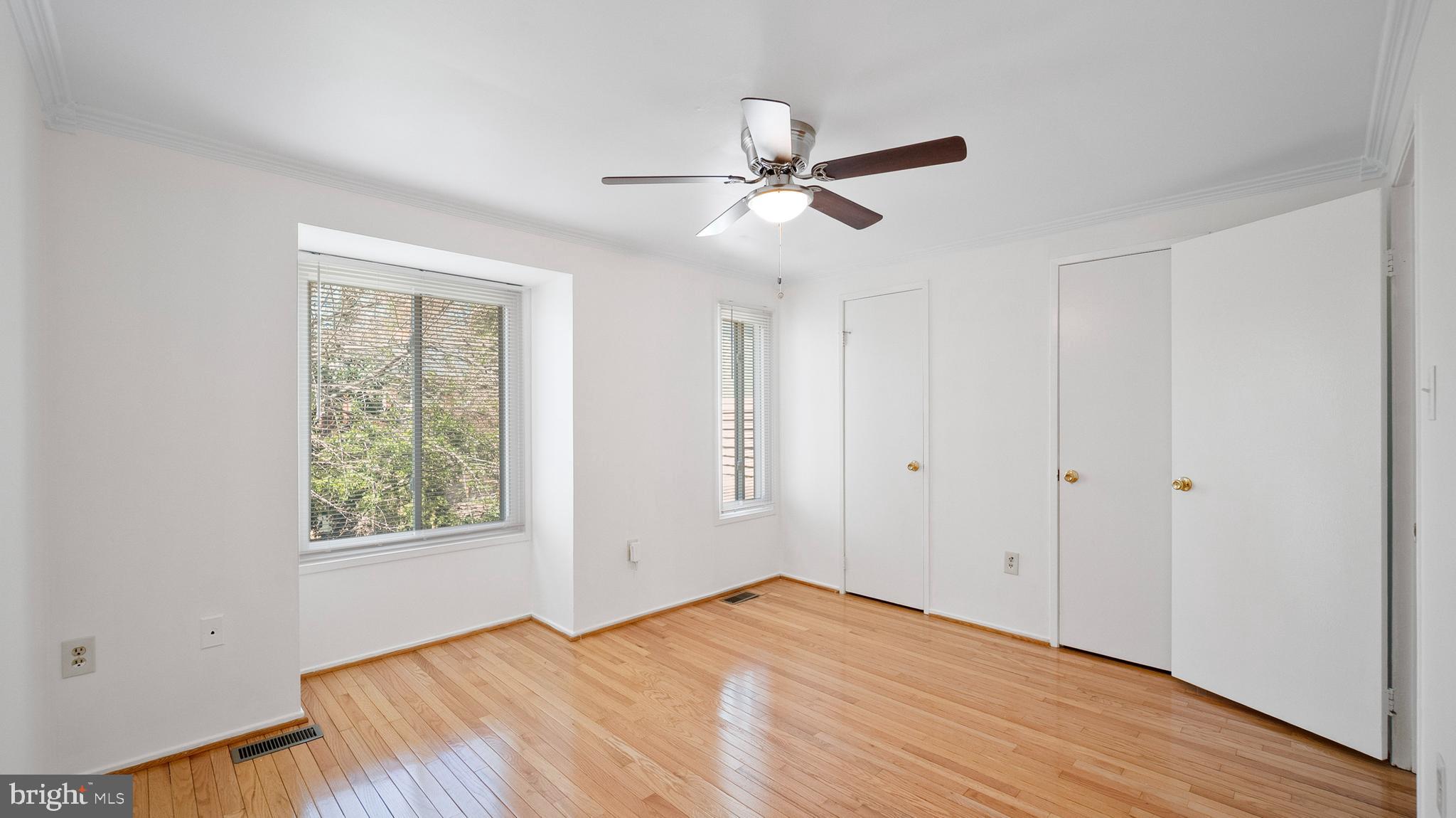 10710 Lester Street Silver Spring, MD 20902 - Photo 13 of 24 a view of empty room with wooden floor and fan