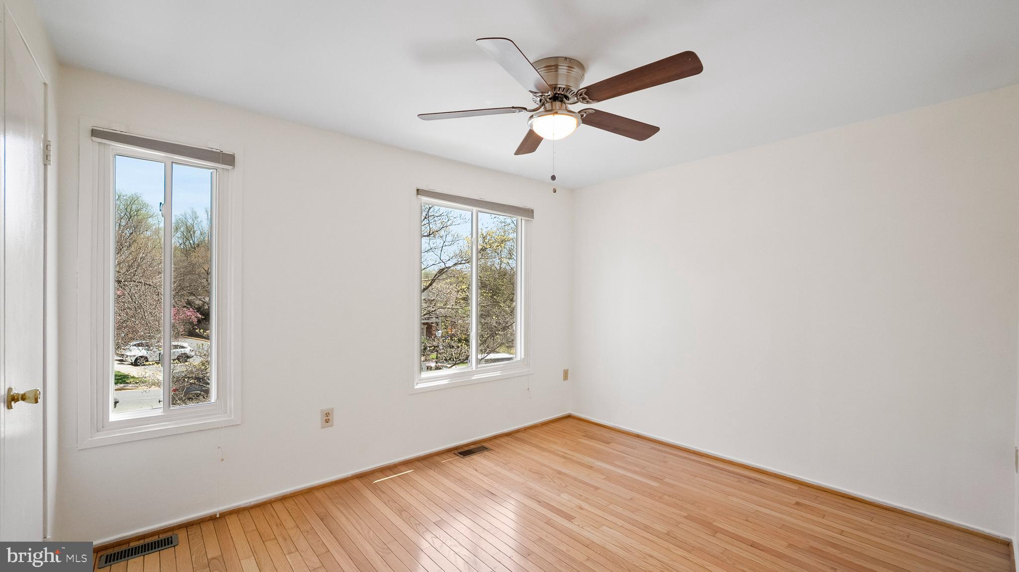 10710 Lester Street Silver Spring, MD 20902 - Photo 17 of 24 an empty room with wooden floor fan and windows