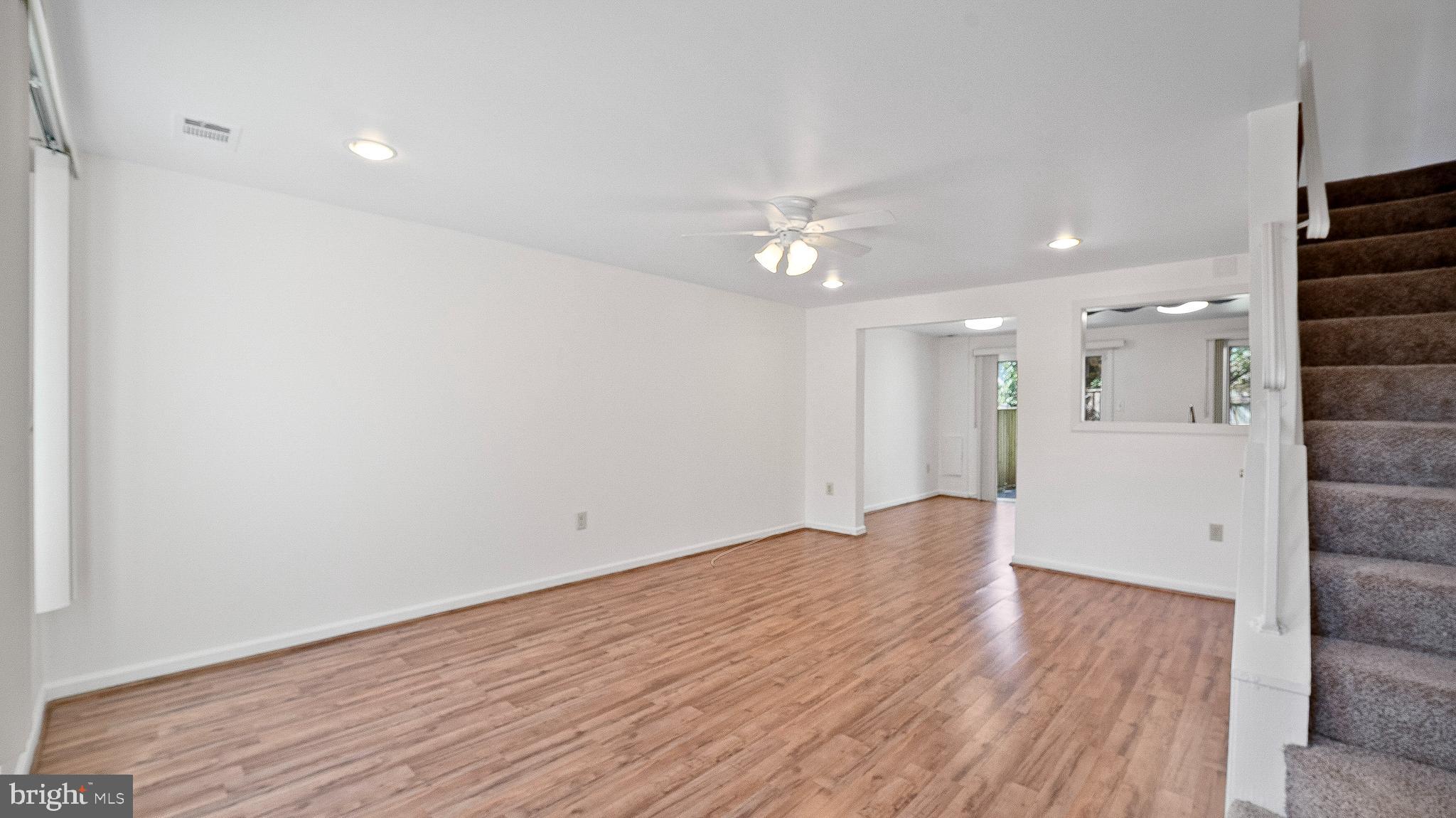 10710 Lester Street Silver Spring, MD 20902 - Photo 5 of 24 an empty room with wooden floor and windows