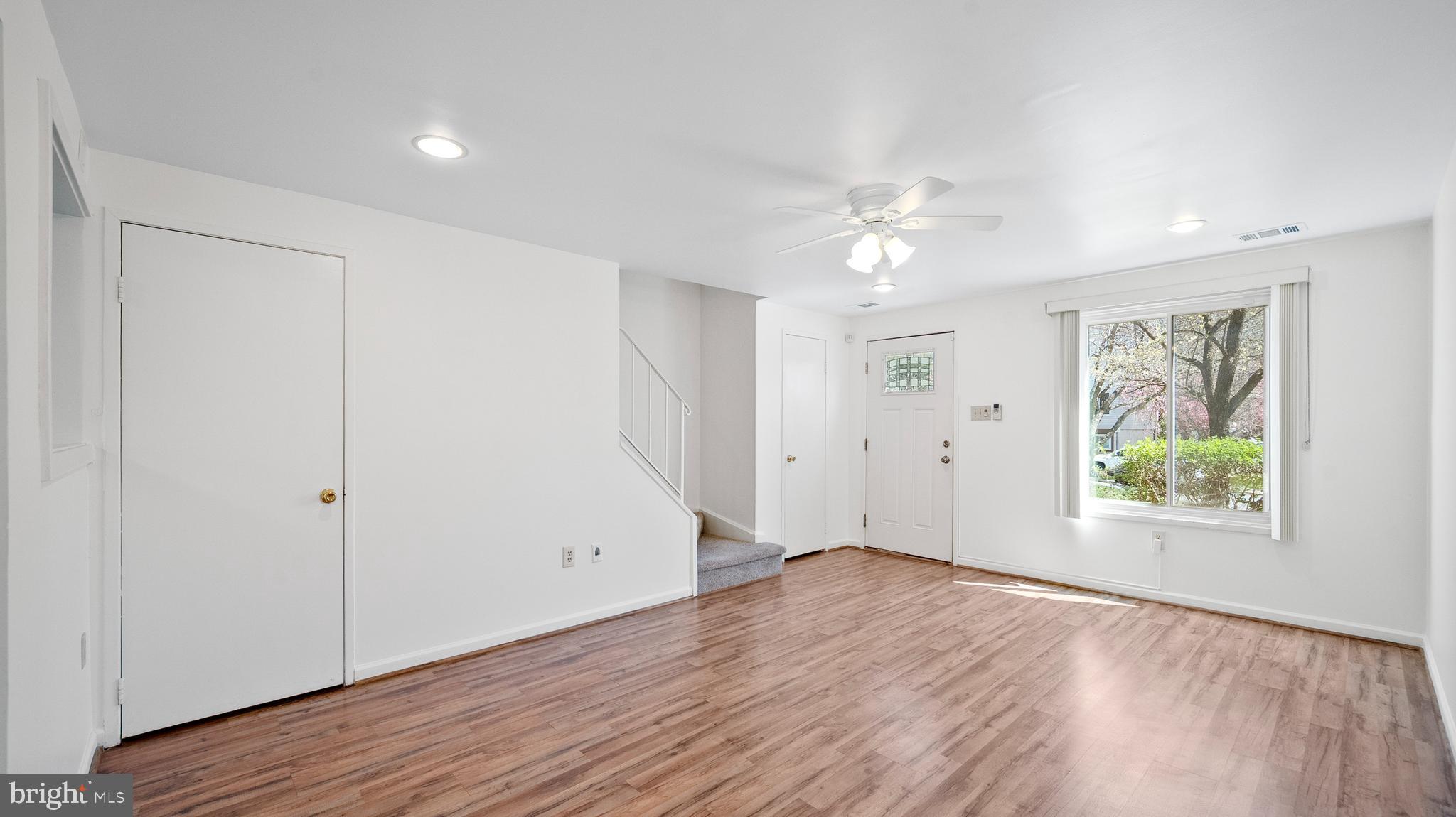 10710 Lester Street Silver Spring, MD 20902 - Photo 6 of 24 an empty room with wooden floor and windows