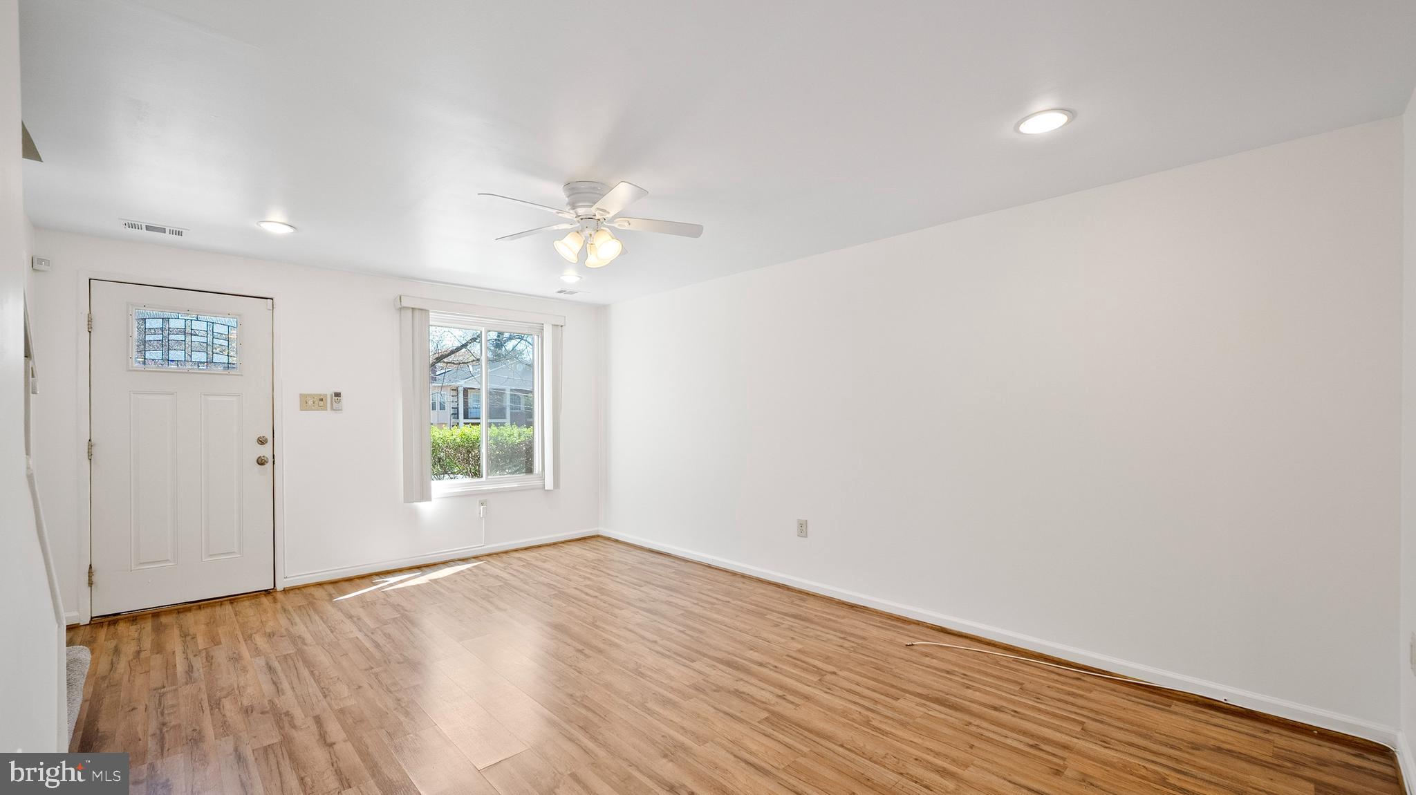 10710 Lester Street Silver Spring, MD 20902 - Photo 7 of 24 wooden floor in an empty room with a window